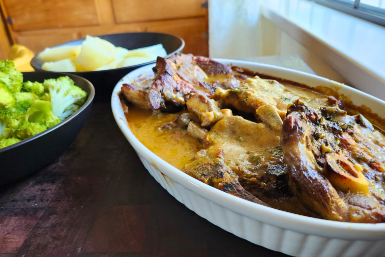 Tender braised lamb chops in a rich, flavourful gravy, served with potatoes and vegetables.