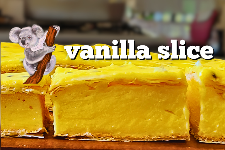 A slice of classic Australian vanilla slice with flaky pastry, creamy custard, and passionfruit icing, on a serving board.