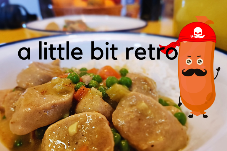 A comforting bowl of curried sausages served with fluffy white rice.