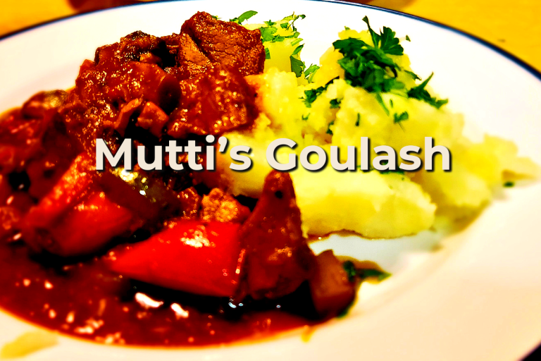 A hearty bowl of Mutti’s German Goulash with tender beef, pork, red peppers, and mushrooms, served with buttery crushed potatoes and fresh parsley.
