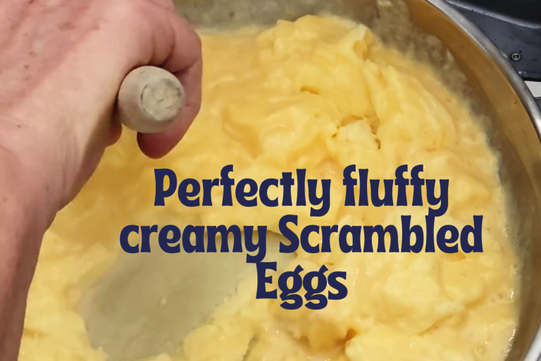 Soft, fluffy scrambled eggs with large curds on toast, made using a slow, low-heat cooking technique.