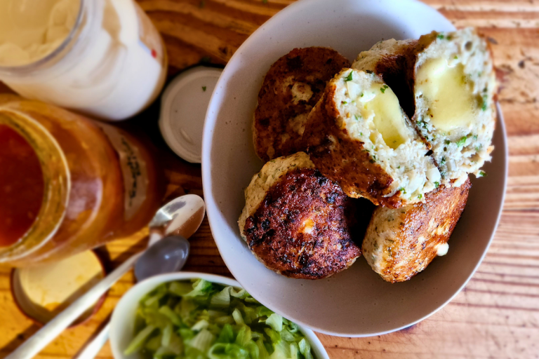 Chicken rissoles with a melted cheese centre served with salad.