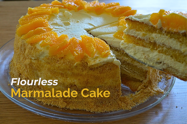 A gluten-free German marmalade cake topped with whipped cream and marmalade