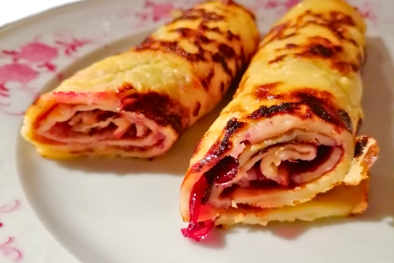 Soft and tender German pancakes rolled with raspberry jam.