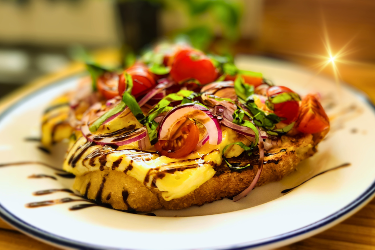 Toasted sourdough topped with golden halloumi, cherry tomatoes, red onion, and fresh basil, drizzled with caramelised balsamic.