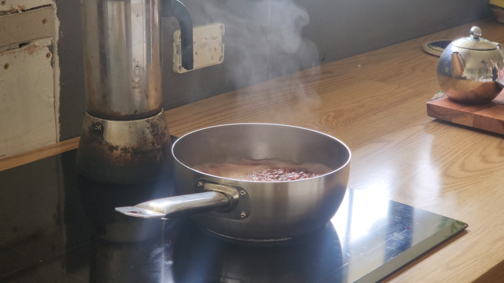 Steam rising from a saucepan while cooking Sauerbraten marinade