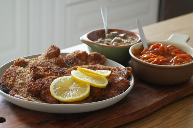 Crumbed pork schnitzel served with mushroom sauce and red pepper gypsy sauce