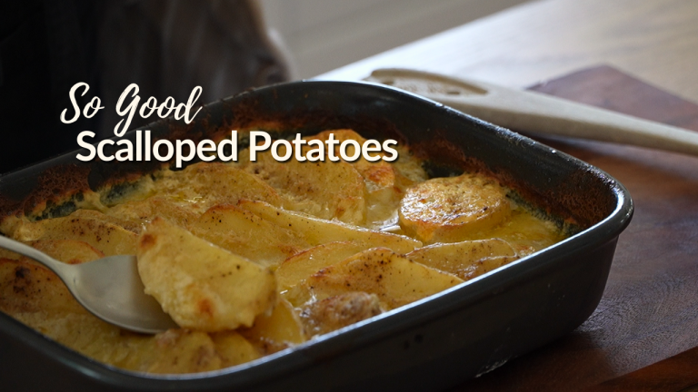 Thick-cut scalloped potatoes baked in a casserole dish until golden and tender