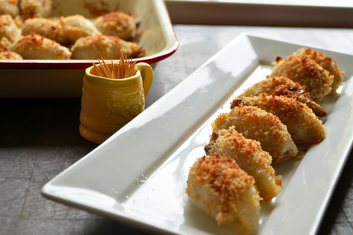 Baked Swedish stuffed onion rolls served on a white rectangular platter