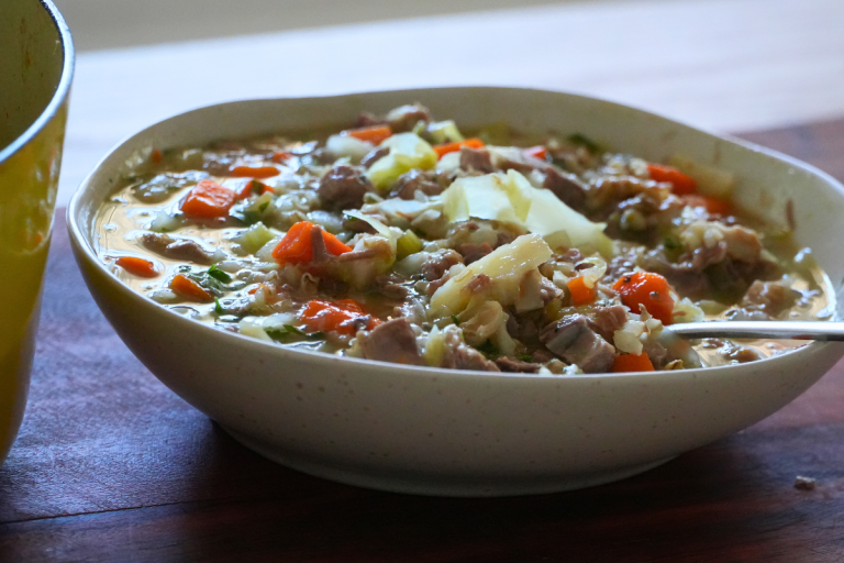 A bowl of Lamb Scotch Broth with tender lamb, barley, and root vegetables