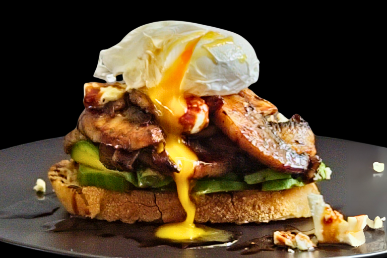 Poached egg on toast with creamy avocado, buttery mushrooms, Persian fetta, and caramelised balsamic
