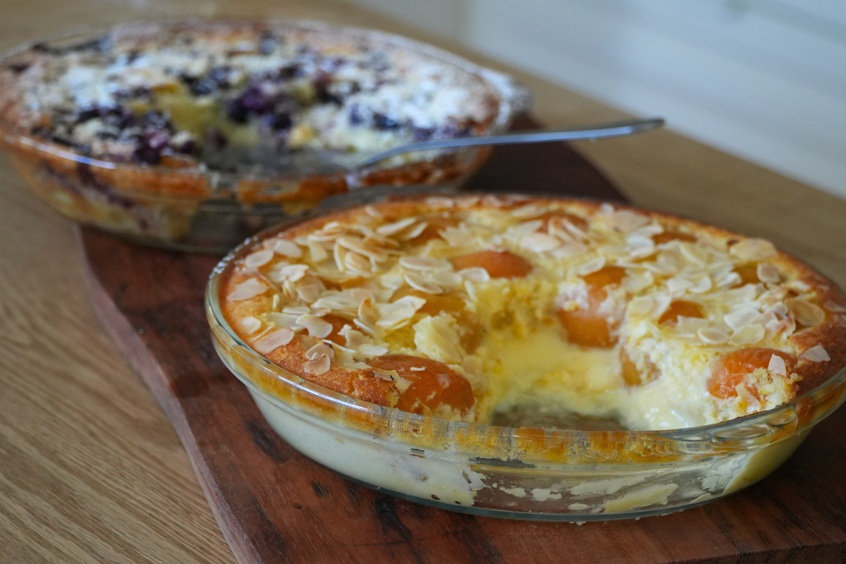 Apricot almond impossible pie in a glass pie dish, topped with flaked almonds