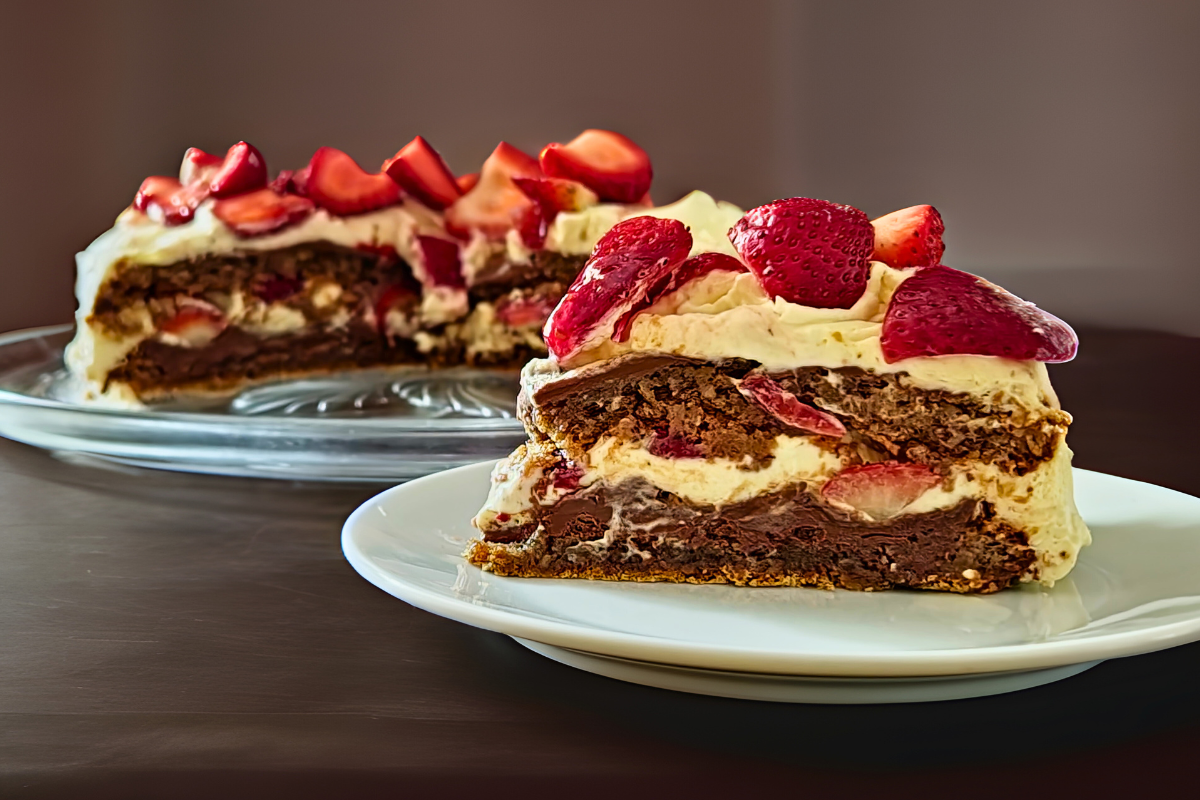 Slice of gluten-free hazelnut torte with Nutella, whipped cream, and fresh strawberries.