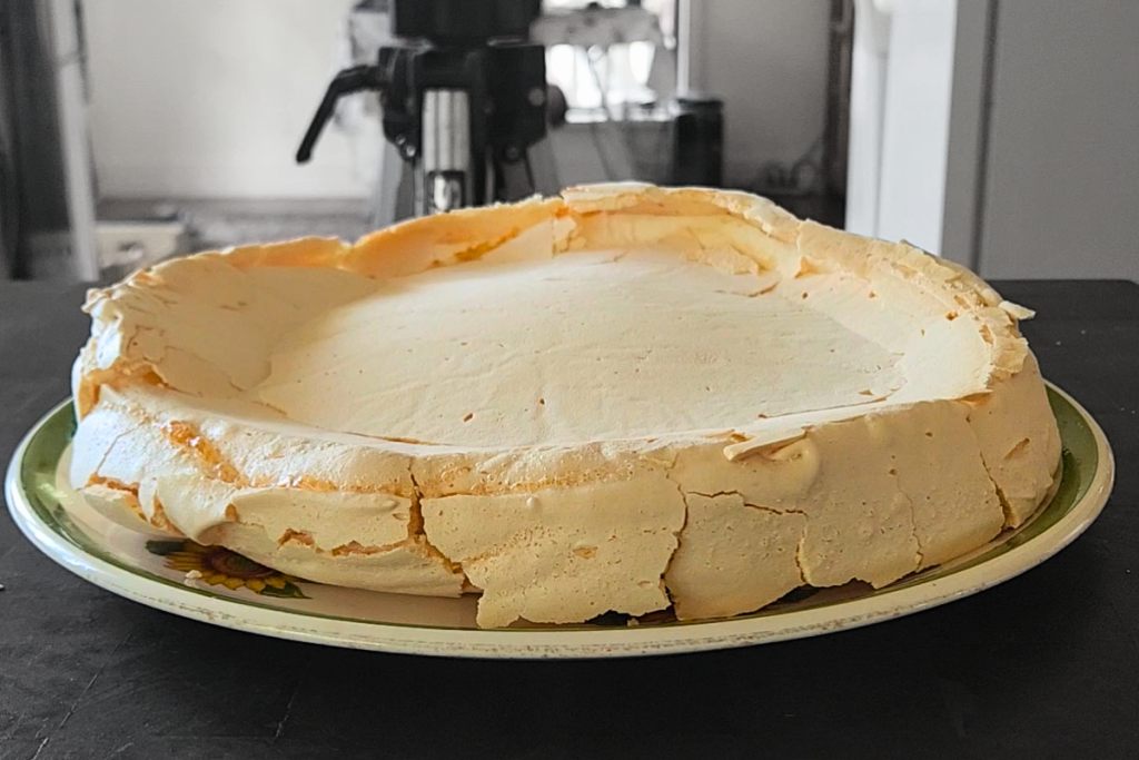Australian pavlova with a sunken centre after baking, showing the natural hollow for cream and fruit