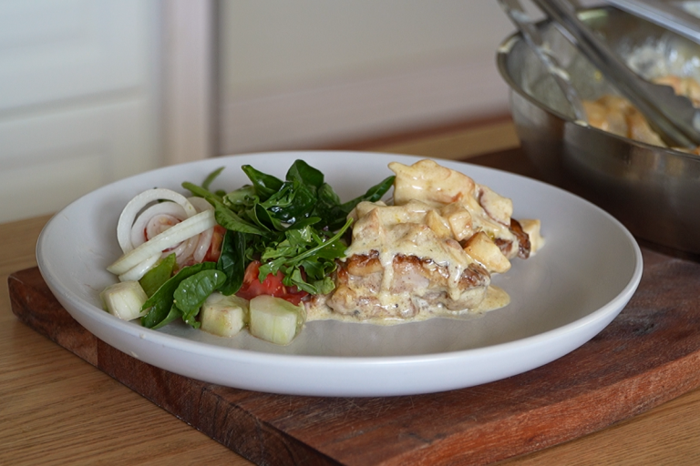 Plated Chicken Celestine served with baked apples, almond cream sauce and a simple green salad
