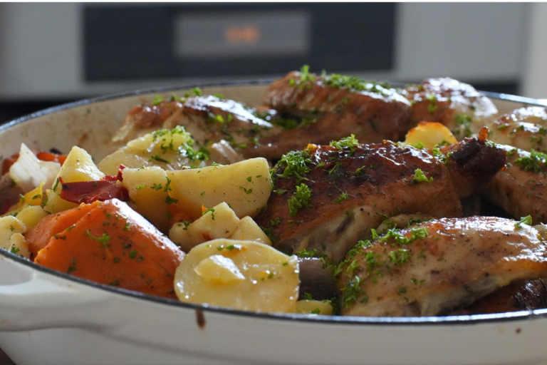Golden roasted chicken with potatoes, sweet potato, capsicum and halloumi in a casserole dish